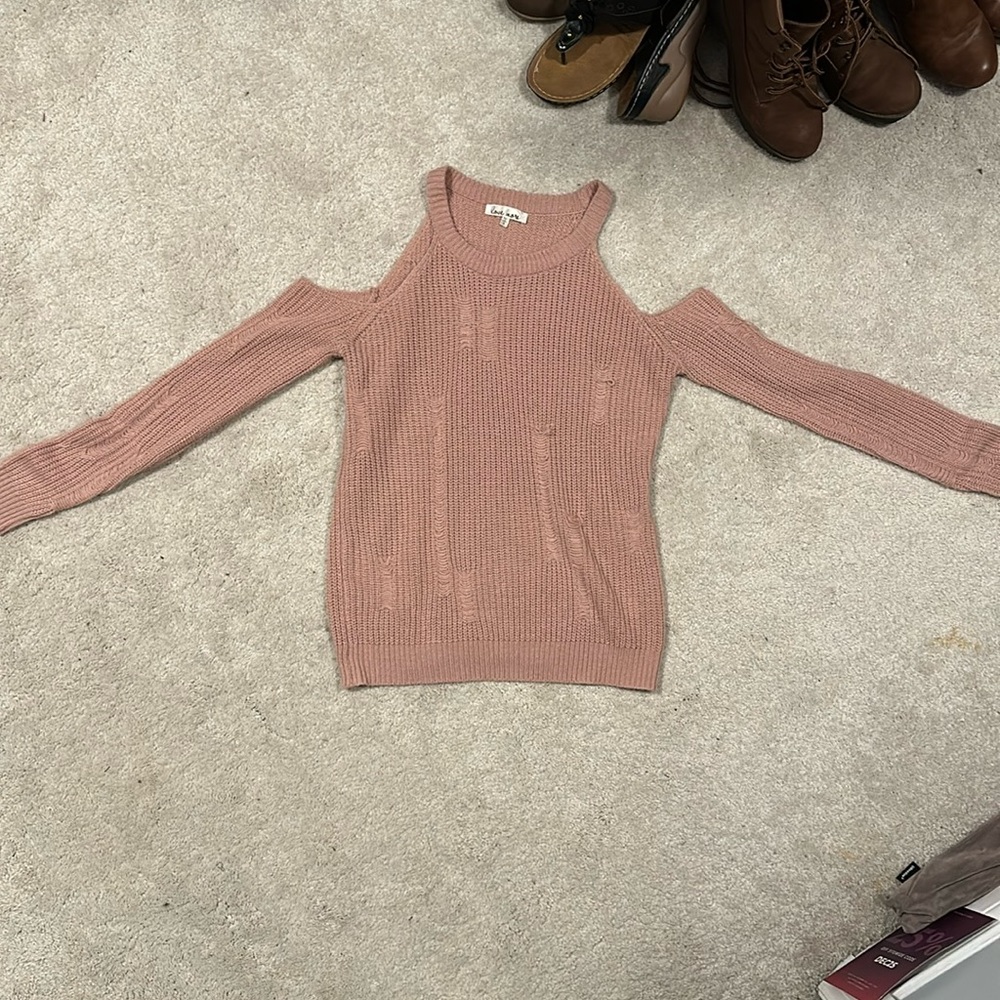 Pink distressed sweater with shoulder cut outs.
